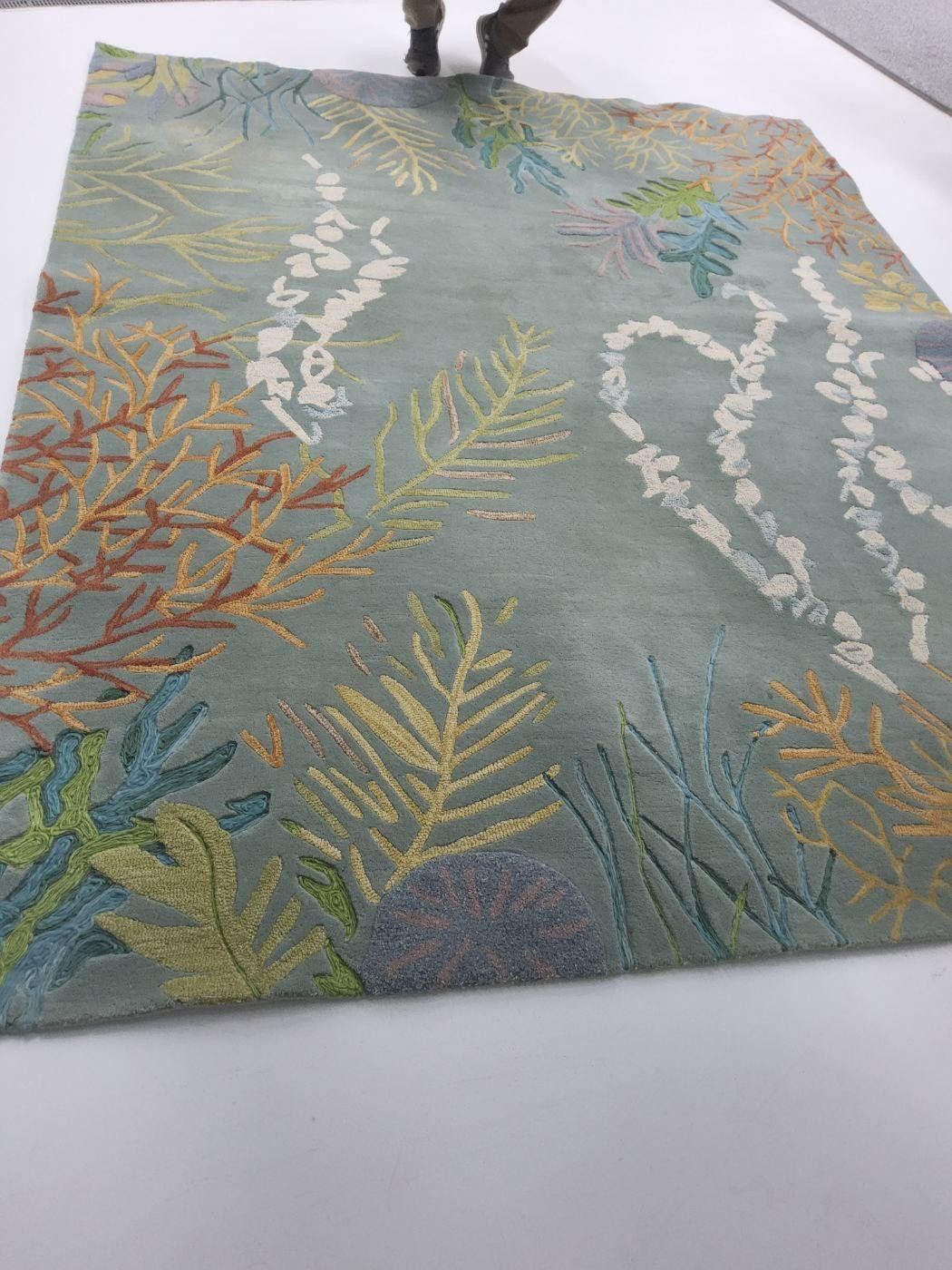 The same coral and leaf pattern rug after cleaning