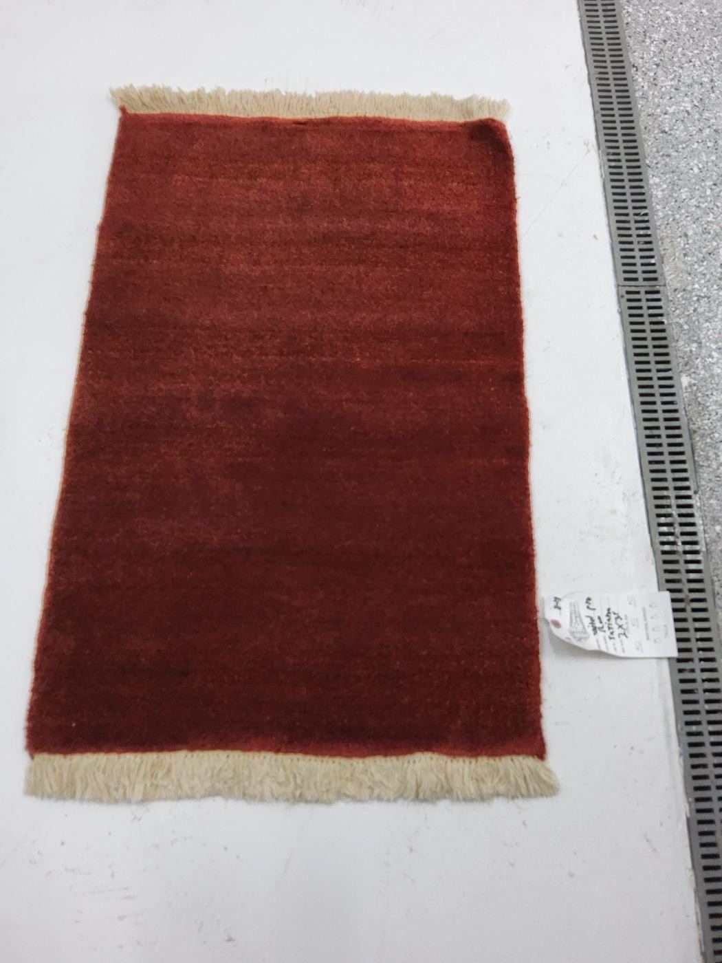 The same red area rug after cleaning